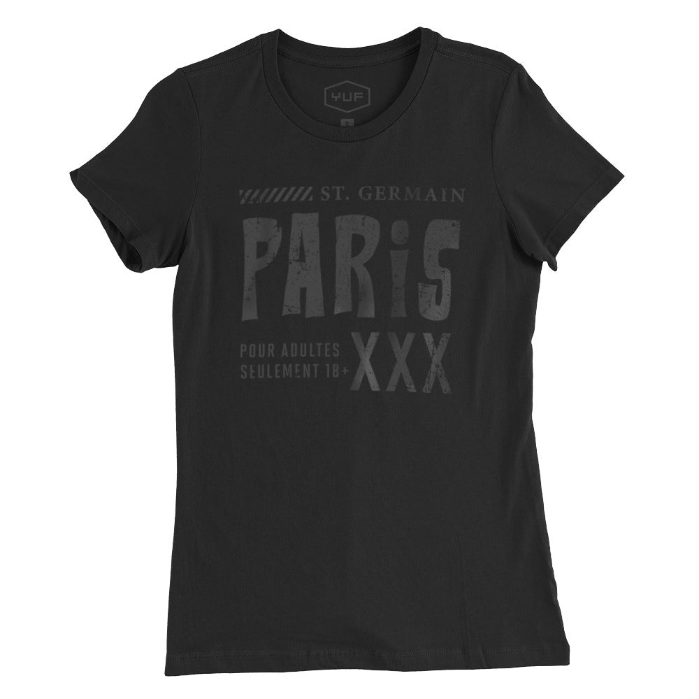 A fashionable, vintage-inspired retro graphic women’s t-shirt in Classic Black. On the shirt is a sarcastic promotion of the adult entertainment district in St. Germain, with the large word “PARIS” and “XXX” most prominent. By fashion brand YUF. From wolfsaint.net