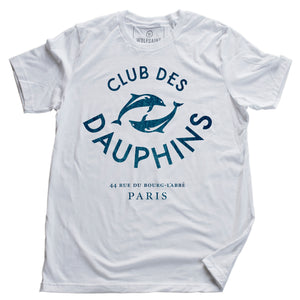 A vintage-inspired fashion t-shirt featuring a retro graphic of two dolphins, surrounded by the words “CLUB DES DAUPHINS,” or Dolphin Club in French, a fictitious club in Paris, France. By fashion brand Wolfsaint. From Wolfsaint.net