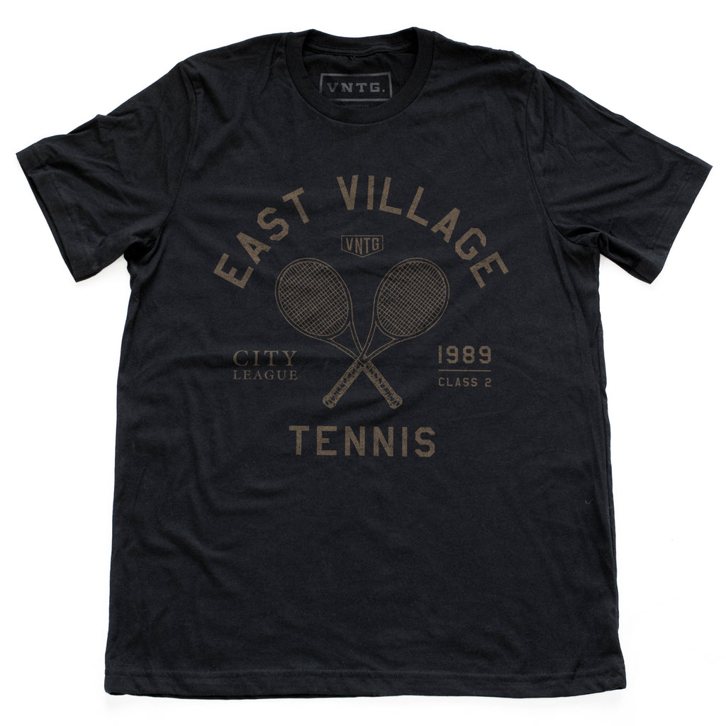 Retro, vintage-inspired graphic t-shirt for a fictional East Village (New York City) city tennis league, featuring a graphic of a crossed set of tennis racquets and the words "East Village" in an arc above. By fashion brand VNTG., from www.wolfsaint.net