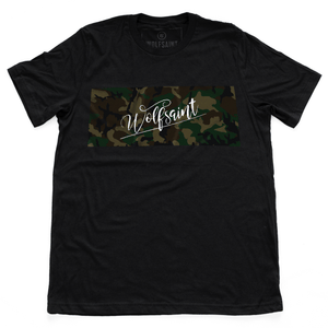 A GIF showing both sides of a fashionable black t-shirt with a camo / camouflage panel on both sides. On the front there is also a Wolfsaint script logo within the camo panel; on the reverse are the Wolfsaint cities “New York, Rio de Janeiro, Los Angeles” listed innsmaller type below the camouflage. From Wolfsaint.net