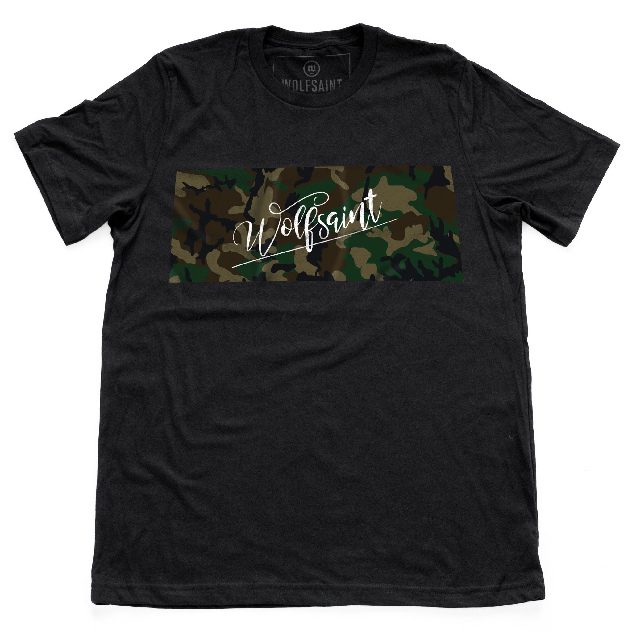 The front of a fashionable black t-shirt with a camo / camouflage panel on both sides. On the front there is also a Wolfsaint script logo within the camo panel; on the reverse are the Wolfsaint cities “New York, Rio de Janeiro, Los Angeles” listed innsmaller type below the camouflage. From Wolfsaint.net