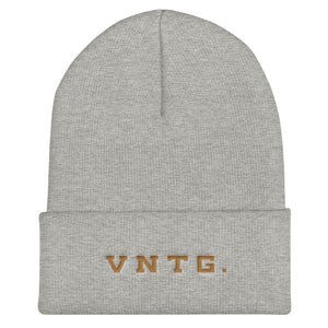 A stylish knit cap or beanie in classic light gray, with the brand logo VNTG. embroidered in gold thread. From wolfsaint.net