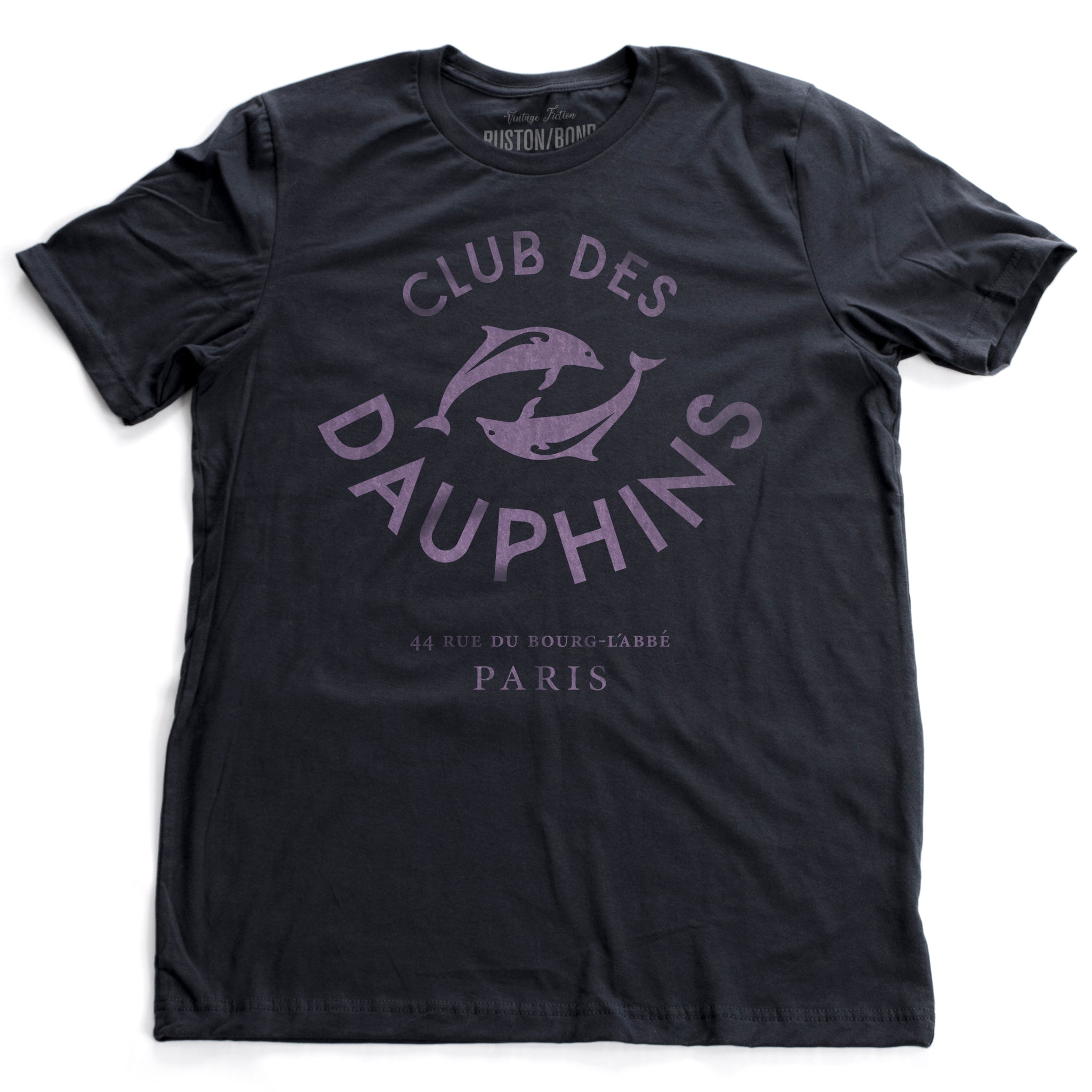 A vintage-inspired fashion t-shirt featuring a retro graphic of two dolphins, surrounded by the words “CLUB DES DAUPHINS,” or Dolphin Club in French, a fictitious club in Paris, France. By fashion brand Wolfsaint. From Wolfsaint.net
