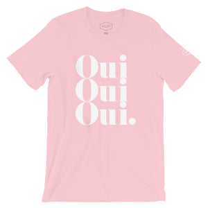 A stylish retro graphic t-shirt with a vintage typographic treatment repeating the French word “Oui” (Yes) three times. In white on soft Pink, by fashion brand YUF, from wolfsaint.net