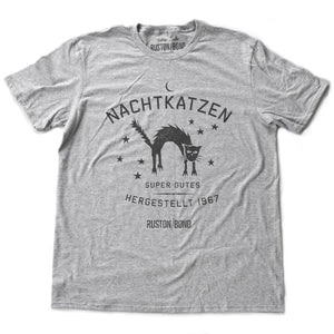 A vintage-inspired retro design graphic t-shirt in classic Athletic Heather Gray, featuring the image of an arched cat among stars, and the German text “NACHTKATZEN, Super Gutes” — translating to “Night Cats, super good” and the year 1967, with the Ruston/Bond logo beneath. From wolfsaint.net