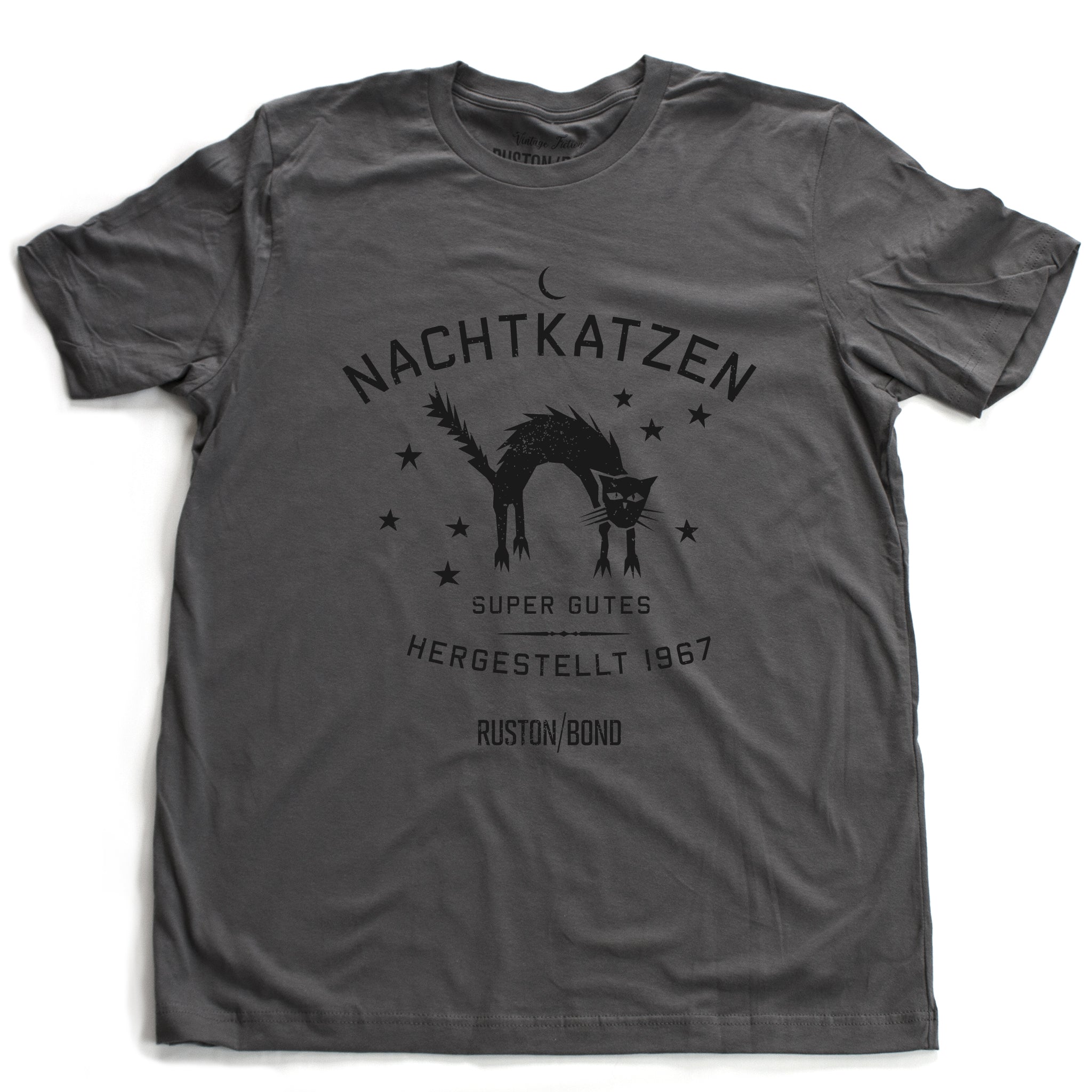 A vintage-inspired retro design graphic t-shirt in Asphalt Gray, featuring the image of an arched cat among stars, and the German text “NACHTKATZEN, Super Gutes” — translating to “Night Cats, super good” and the year 1967, with the Ruston/Bond logo beneath. From wolfsaint.net