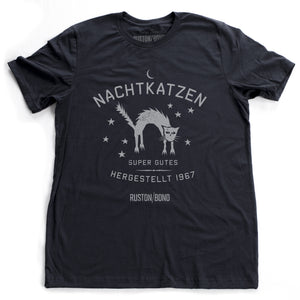 A vintage-inspired retro design graphic t-shirt in classic Navy Blue, featuring the image of an arched cat among stars, and the German text “NACHTKATZEN, Super Gutes” — translating to “Night Cats, super good” and the year 1967, with the Ruston/Bond logo beneath. From wolfsaint.net