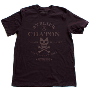 Maroon or burgundy (oxblood) retro, vintage-inspired fashion t-shirt for a fictional graphic design studio in Paris and New York, featuring a graphic of a cat skull and cross bones, from brand Ruston/Bond. From wolfsaint.net