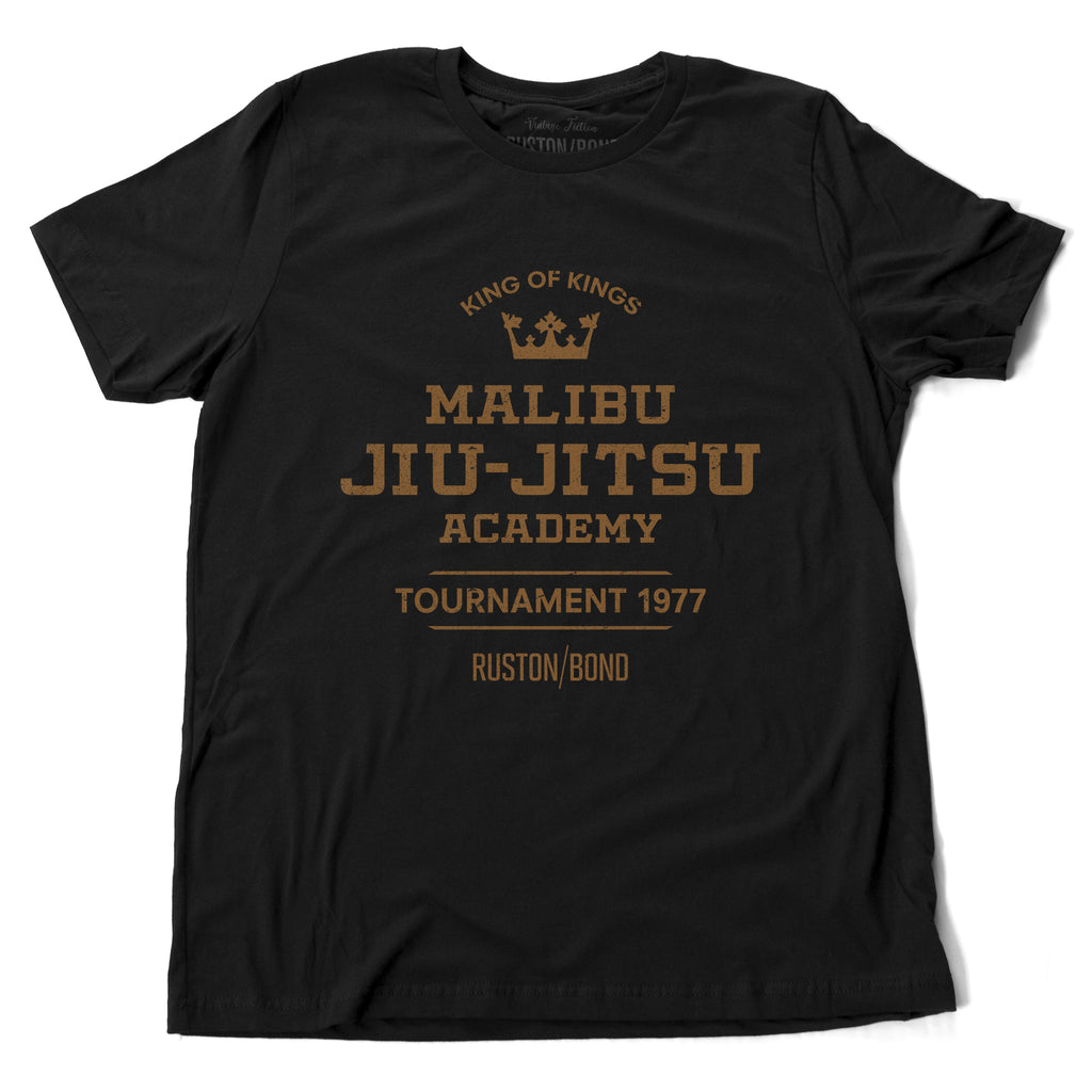 A fashionable, vintage-inspired retro t-shirt in Classic Black, featuring a graphic commemorating a sarcastic and fictitious Malibu (California) Jiu Jitsu academy and a 1977 tournament. By fashion brand Ruston/Bond, from wolfsaint.net