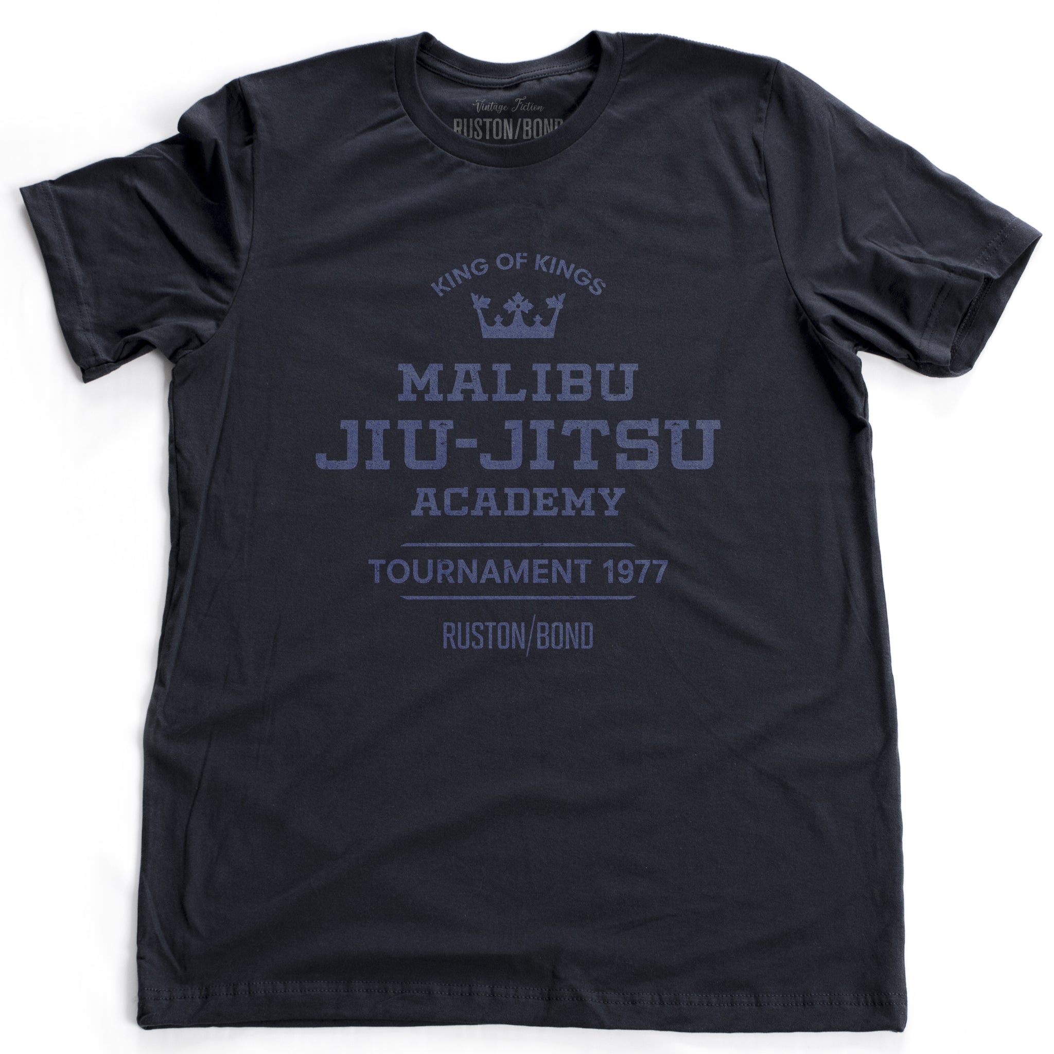 A fashionable, vintage-inspired retro t-shirt in classic Navy Blue, featuring a graphic commemorating a sarcastic and fictitious Malibu (California) Jiu Jitsu academy and a 1977 tournament. By fashion brand Ruston/Bond, from wolfsaint.net