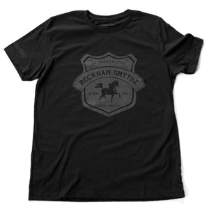 Black fashion style, retro, vintage-inspired t-shirt with a classic graphic of a fictional Tack shop in the Hamptons, New York (Bridgehampton). From the stylish brand Ruston/Bond, with a parody of Hermes style.