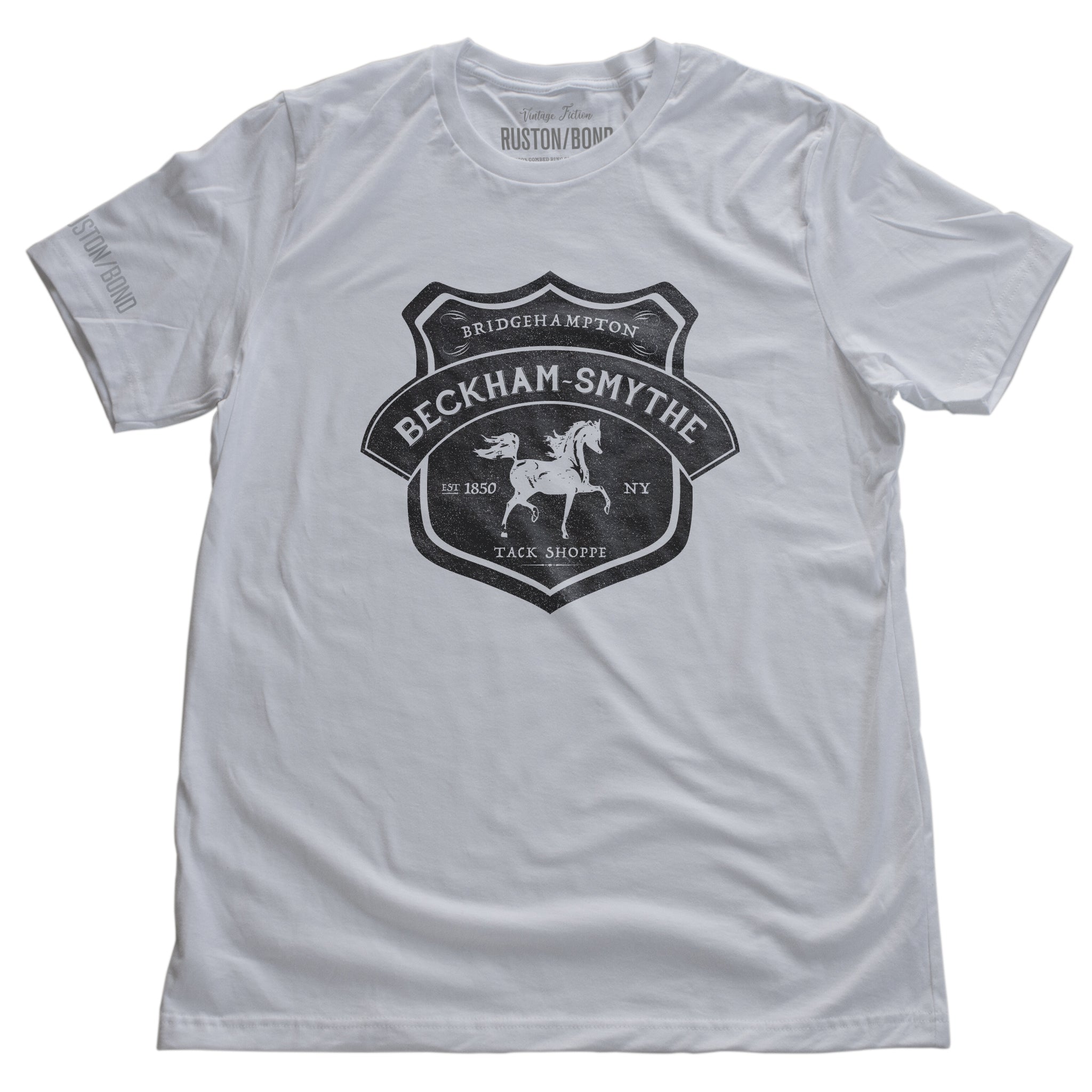 White fashion style, retro, vintage-inspired t-shirt with a classic graphic of a fictional Tack shop in the Hamptons, New York (Bridgehampton). From the stylish brand Ruston/Bond, with a parody of Hermes style.