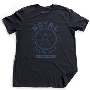 A vintage-inspired Classic Navy Blue t-shirt with a retro graphic of crossed surfboards and a crown, surrounded by the words ROYAL / STAR SURF / COSTA RICA. By the fashion brand Ruston/Bond, for Wolfsaint.net