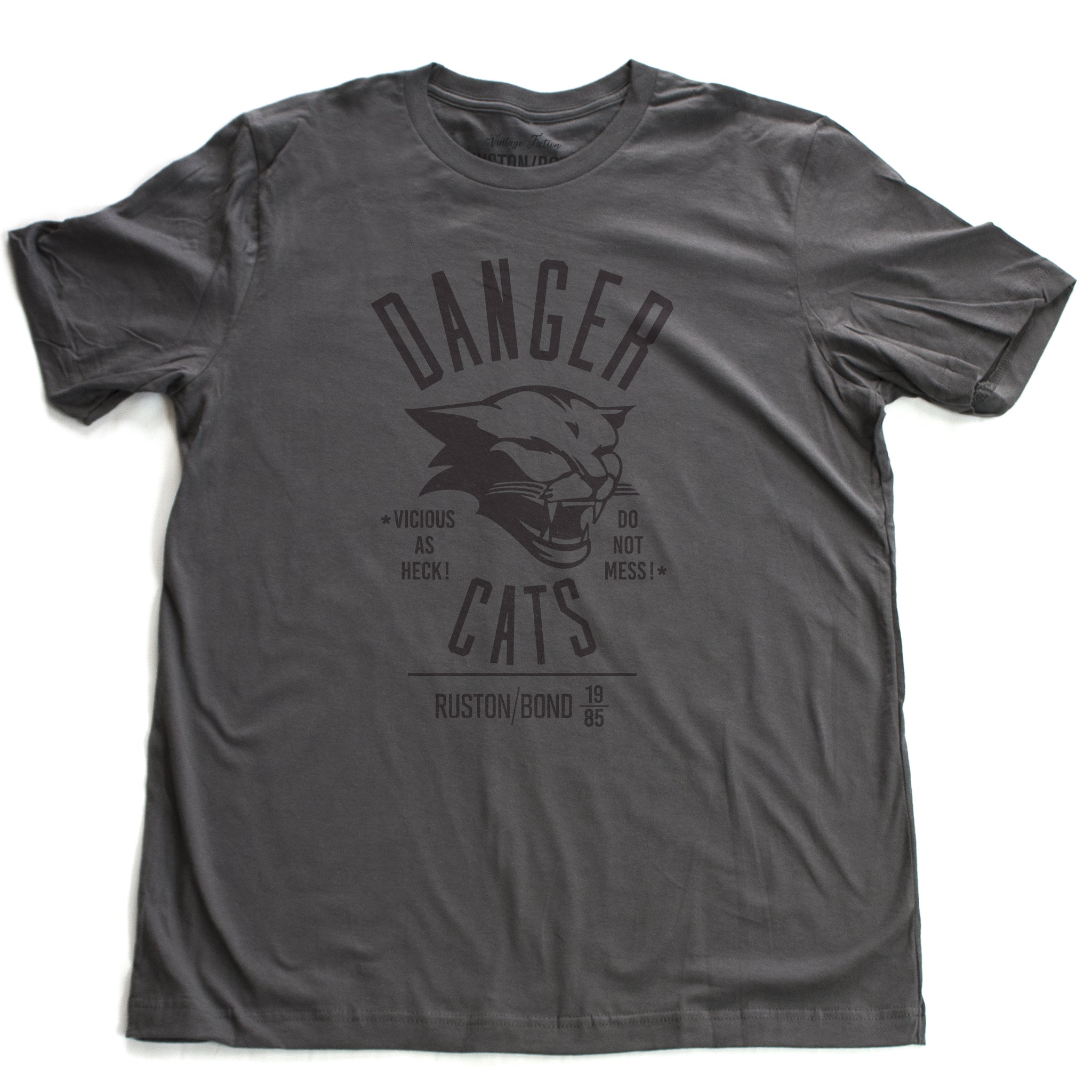 A retro bold, sarcastic graphic t-shirt in dark gray, featuring a mean cat image, with the words DANGER CATS, Vicious as heck—do not mess typography. From fashion brand Ruston/Bond, from wolfsaint.net