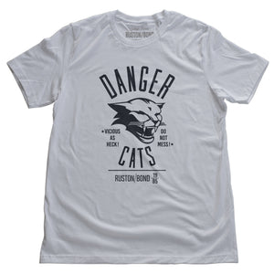 A retro bold, sarcastic graphic t-shirt in white, featuring a mean cat image, with the words DANGER CATS, Vicious as heck—do not mess typography. From fashion brand Ruston/Bond, from wolfsaint.net