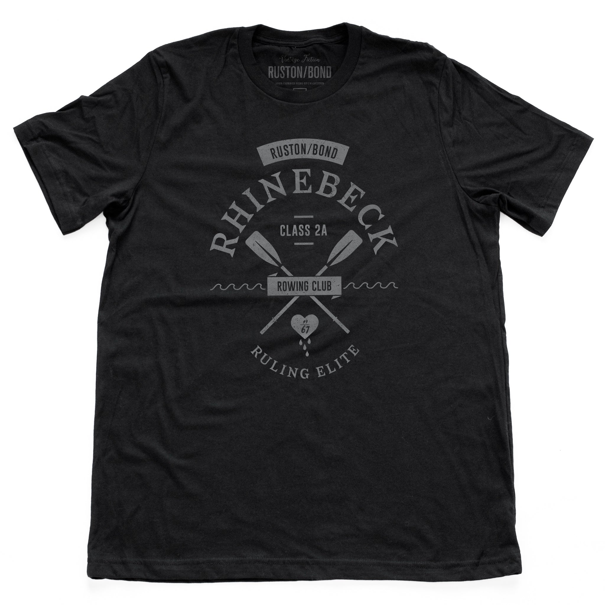 A preppy, vintage-look, retro graphic t-shirt, for a fictional Rhinebeck (New York) rowing club. It depicts two oars over waves, and the celebratory words “ruling elite” below a heart. In classic Black, by fashion brand Ruston/Bond, for a wolfsaint.net