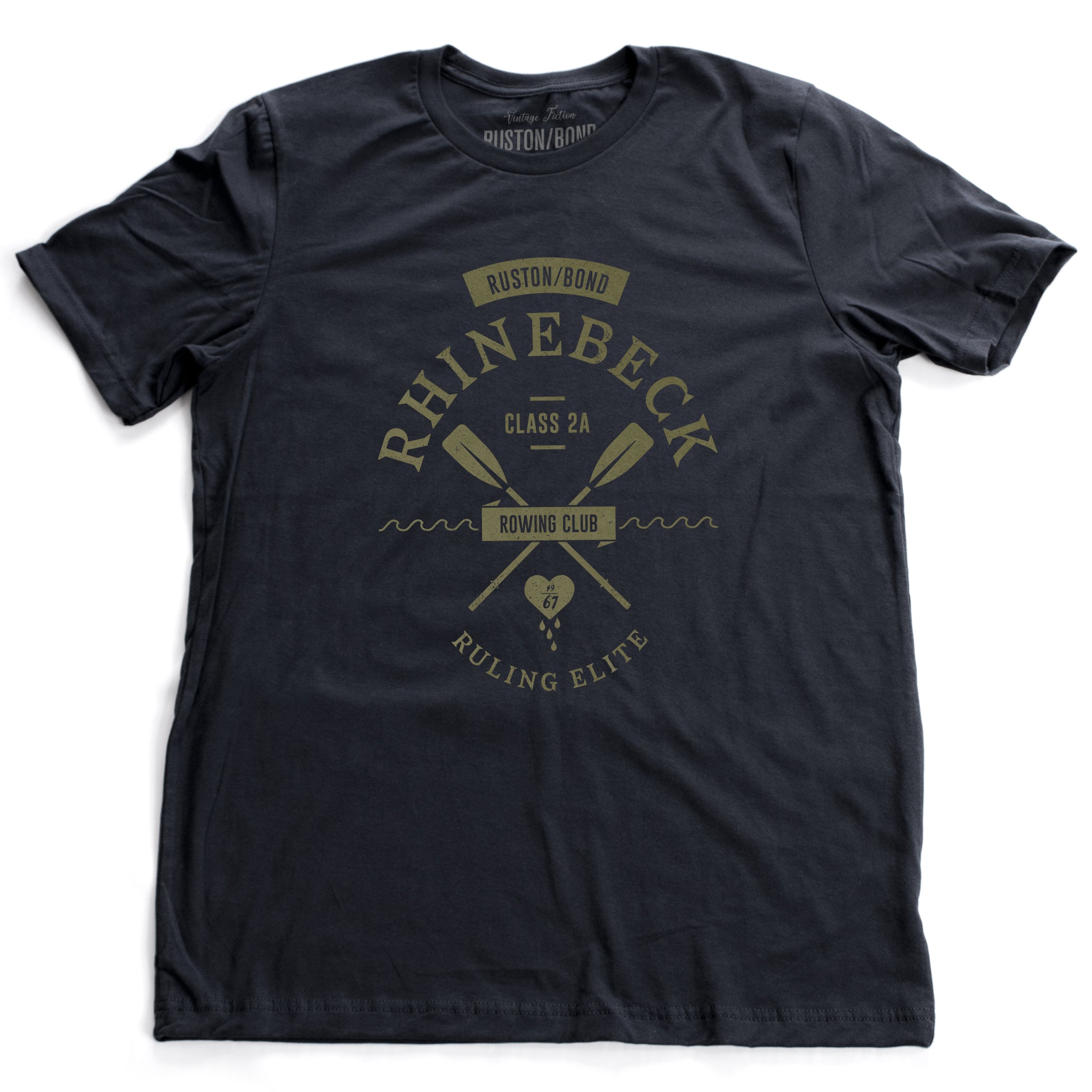 A preppy, vintage-look, retro graphic t-shirt, for a fictional Rhinebeck (New York) rowing club. It depicts two oars over waves, and the celebratory words “ruling elite” below a heart. In classic Navy Blue, by fashion brand Ruston/Bond, for a wolfsaint.net