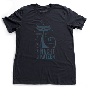 A vintage-inspired retro design t-shirt in classic Navy Blue, featuring the image of a stylized cat graphic among stars, and the German text “NACHTKATZEN, Super Gutes” — translating to “Night Cats, super good” and the year 1967, with the Ruston/Bond logo beneath. From wolfsaint.net