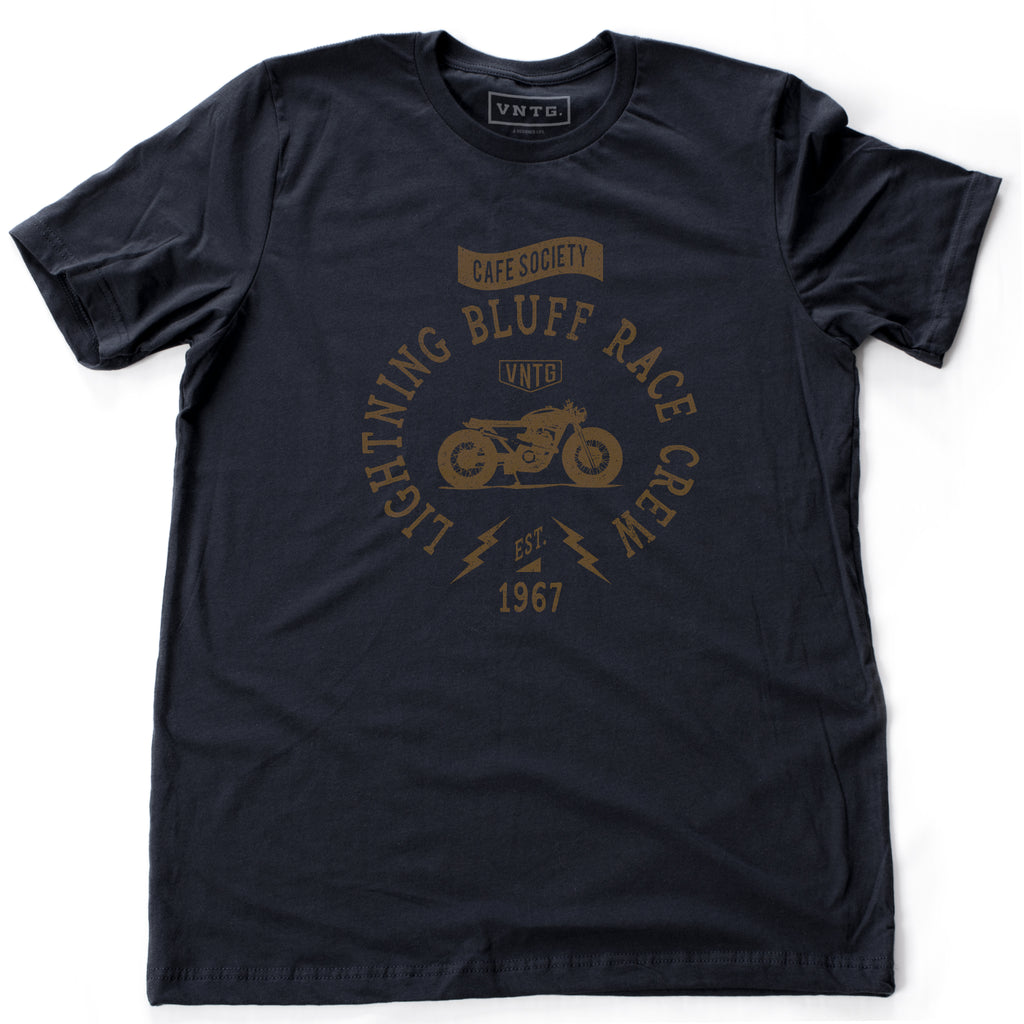 A vintage-inspired retro t-shirt for a fictitious motorcycle race crew. For the café racer genre of vintage motorcycles, this shirt reads “Lightning Bluff Race Crew, established 1967” in Navy Blue, by fashion brand VNTG., for wolfsaint.net 