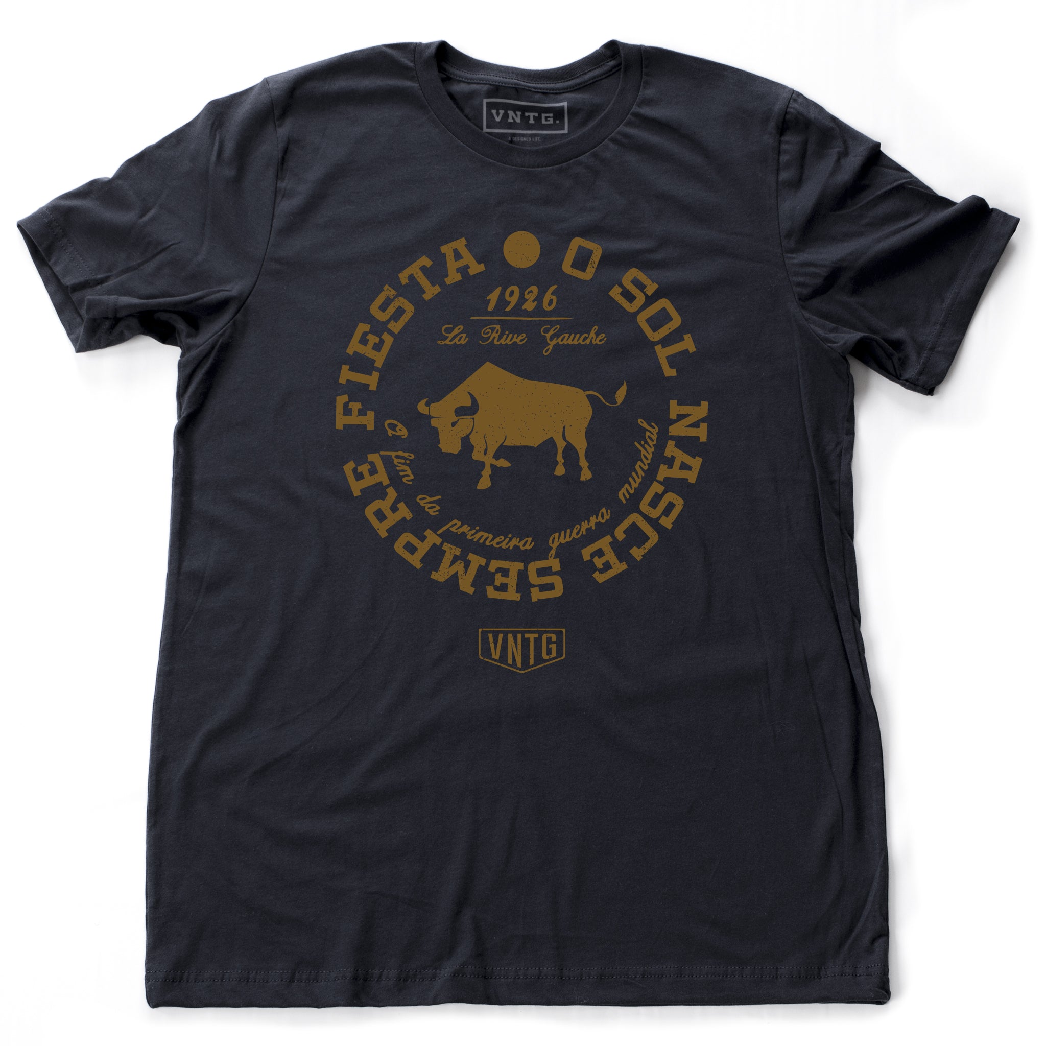 A Classic fashion t-shirt celebrating Ernest Hemingway’s novel “THE SUN ALSO RISES,” in its Portuguese language translation. It reads “O Sol Nasce Sempre Fiesta” around the image of a bull and the date the novel was published, 1926. By fashion brand VNTG., from wolfsaint.net