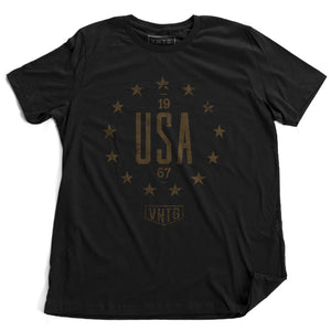 A vintage inspired, classic, retro design, graphic t-shirt with “USA” in large letters, surrounded by 13 stars of the original American colonies, and the VNTG. logo beneath. From wolfsaint.net