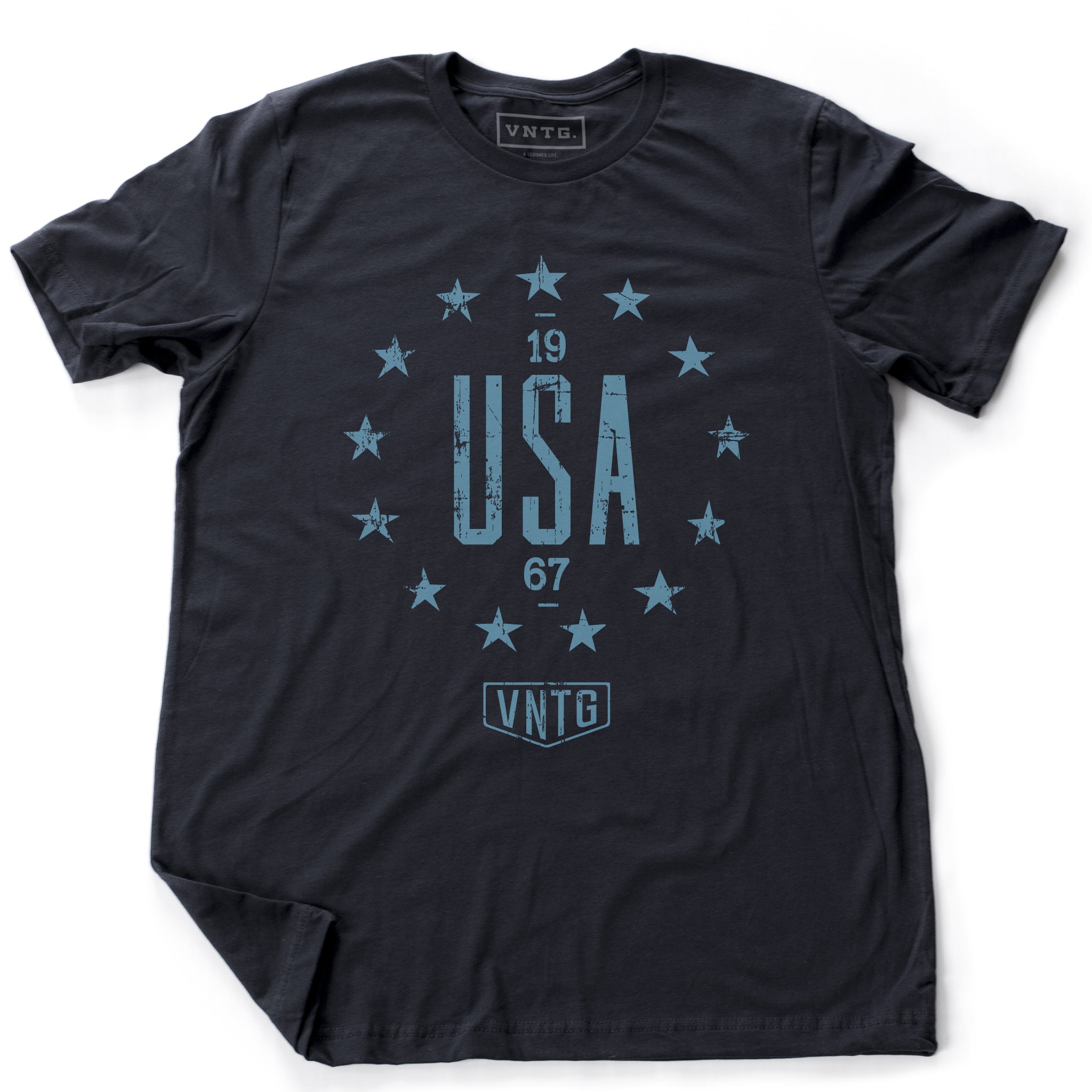 A vintage inspired, classic, retro design, graphic t-shirt with “USA” in large letters, surrounded by 13 stars of the original American colonies, and the VNTG. logo beneath. From wolfsaint.net