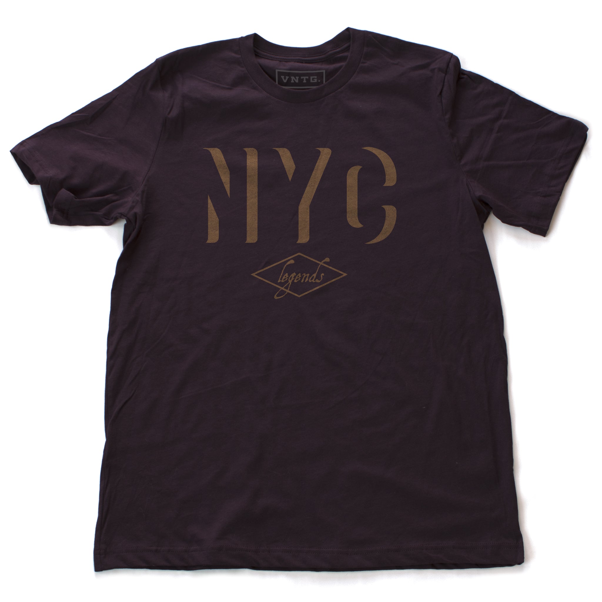 A retro, vintage-inspired t-shirt in Oxblood/deep burgundy, with a bold “NYC” in a gold tone shadow font, and the word “legends” inscript below. By fashion brand VNTG., from wolfsaint.net