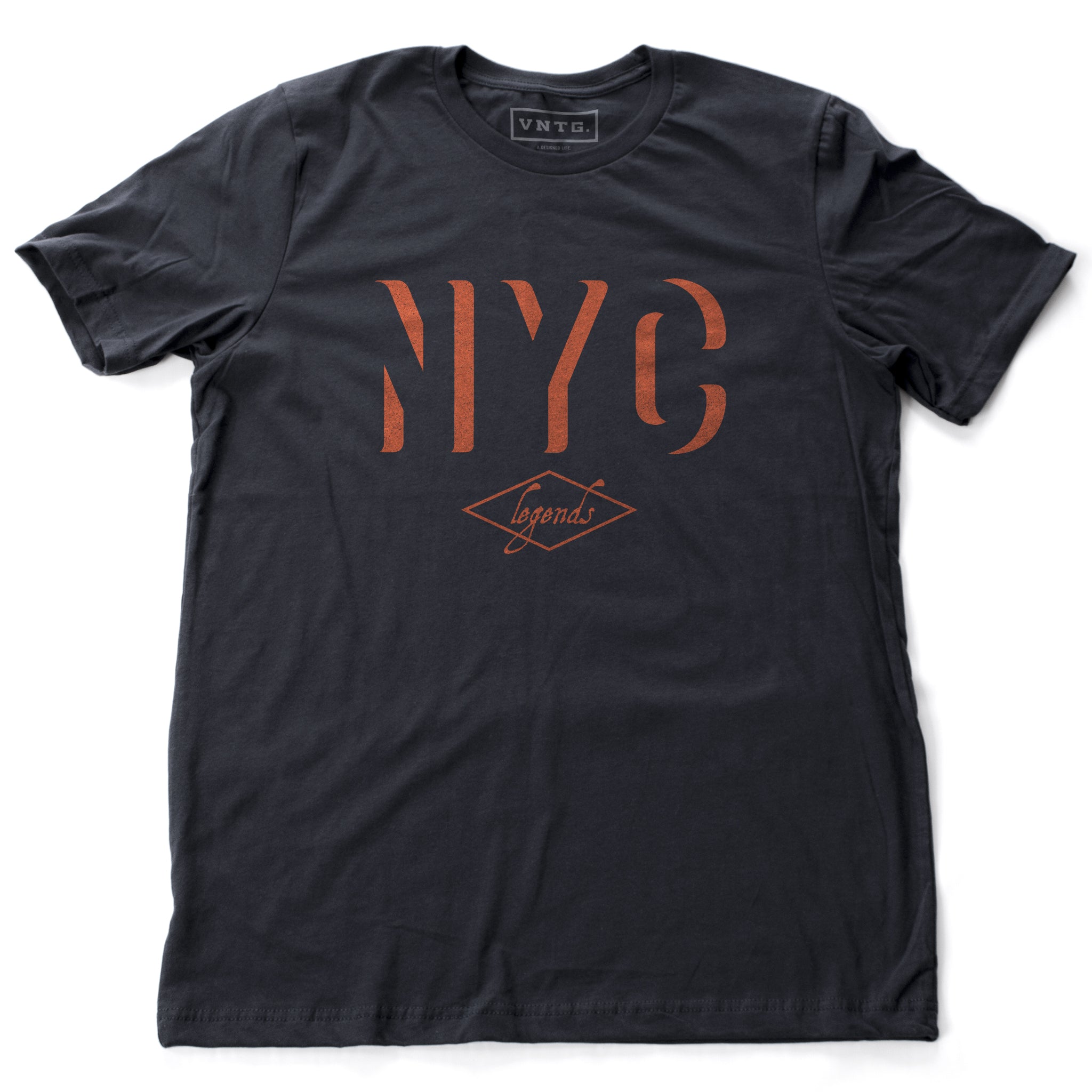 A retro, vintage-inspired t-shirt in Classic Navy Blue with a bold “NYC” in an orange shadow font, and the word “legends” inscript below. By fashion brand VNTG., from wolfsaint.net