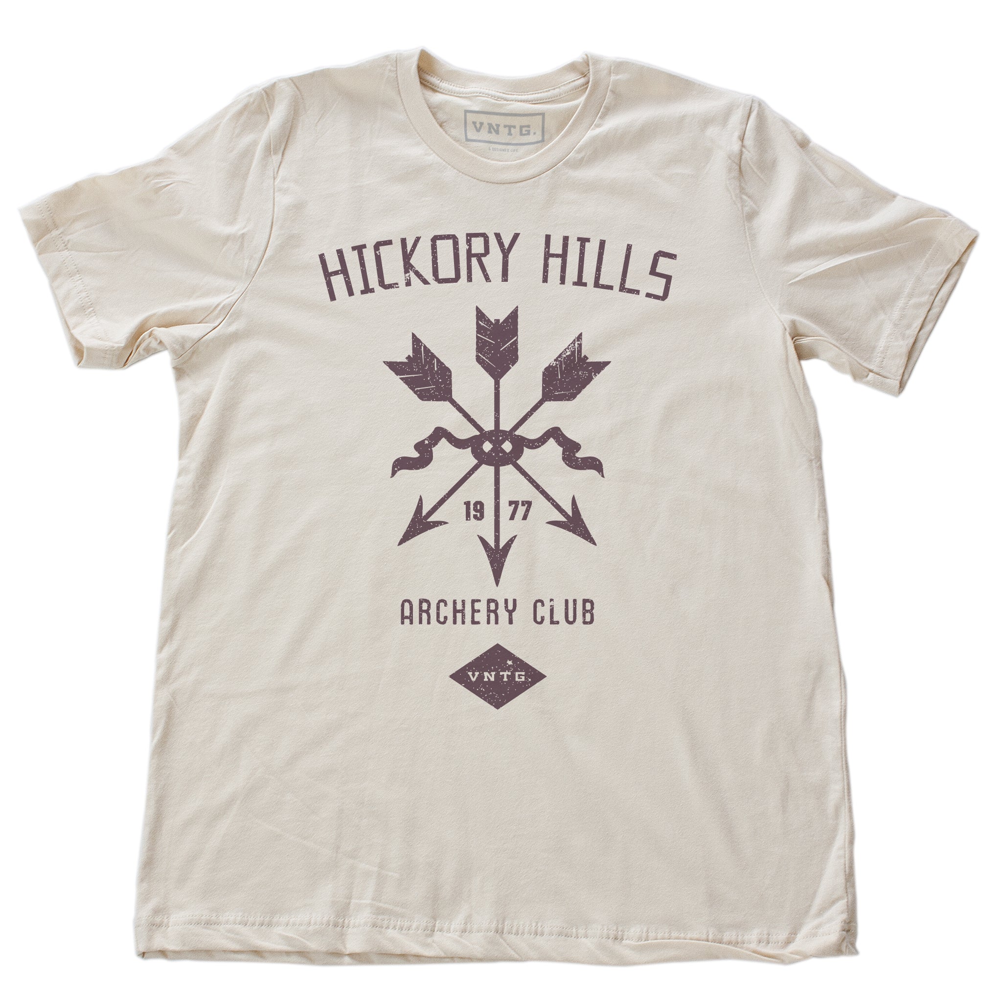 A vintage-inspired retro t-shirt in Soft Cream, featuring a graphic of a quiver of arrows, representing a small town amateur archery club from 1977.  By fashion brand VNTG, from wolfsaint.net