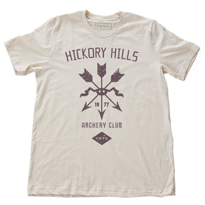 A vintage-inspired retro t-shirt in Soft Cream, featuring a graphic of a quiver of arrows, representing a small town amateur archery club from 1977.  By fashion brand VNTG, from wolfsaint.net