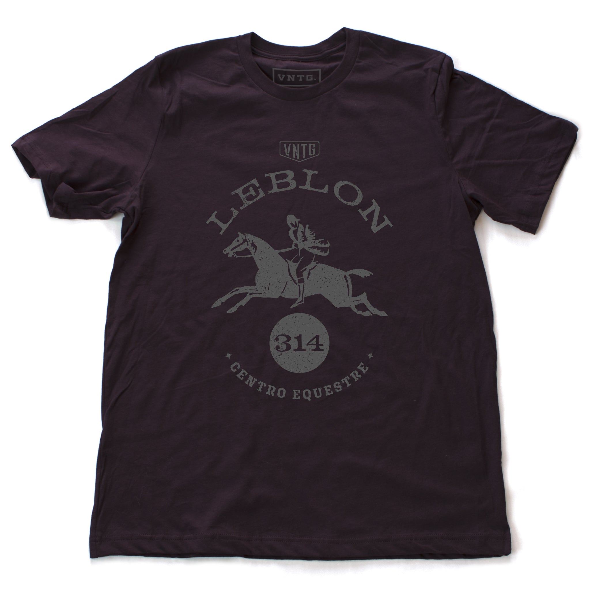 A preppy fashion retro, vintage-inspired t-shirt in Oxblood, featuring a leaping horse in dressage competition, surrounded by the words “Leblon Centro Equestre” (Leblon Equestrian Center) a fictitious horse training and competition facility in Rio de Janeiro, Brazil. By fashion brand VNTG., for wolfsaint.net