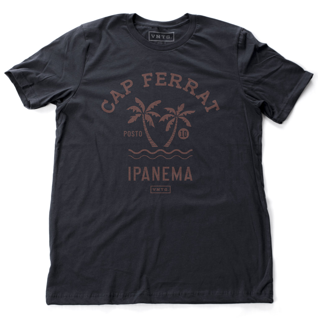 Navy blue fashion t-shirt featuring a stylish retro, vintage-inspired graphic of two palm trees against the waves, and the words Cap Ferrat, Ipanema, a popular beach spot in Rio de Janeiro, Brazil. From wolfsaint.net