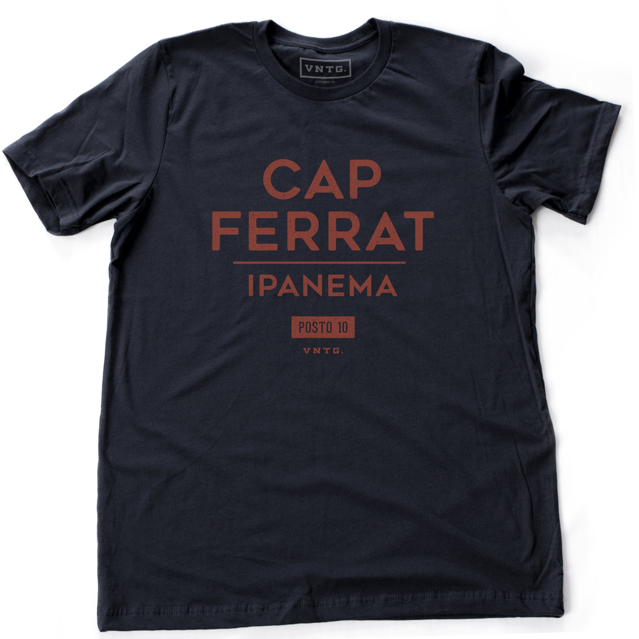 A classic navy blue fashion t-shirt featuring a stylish retro, vintage-inspired graphic typography with the words Cap Ferrat, Ipanema, a popular beach spot in Rio de Janeiro, Brazil. 