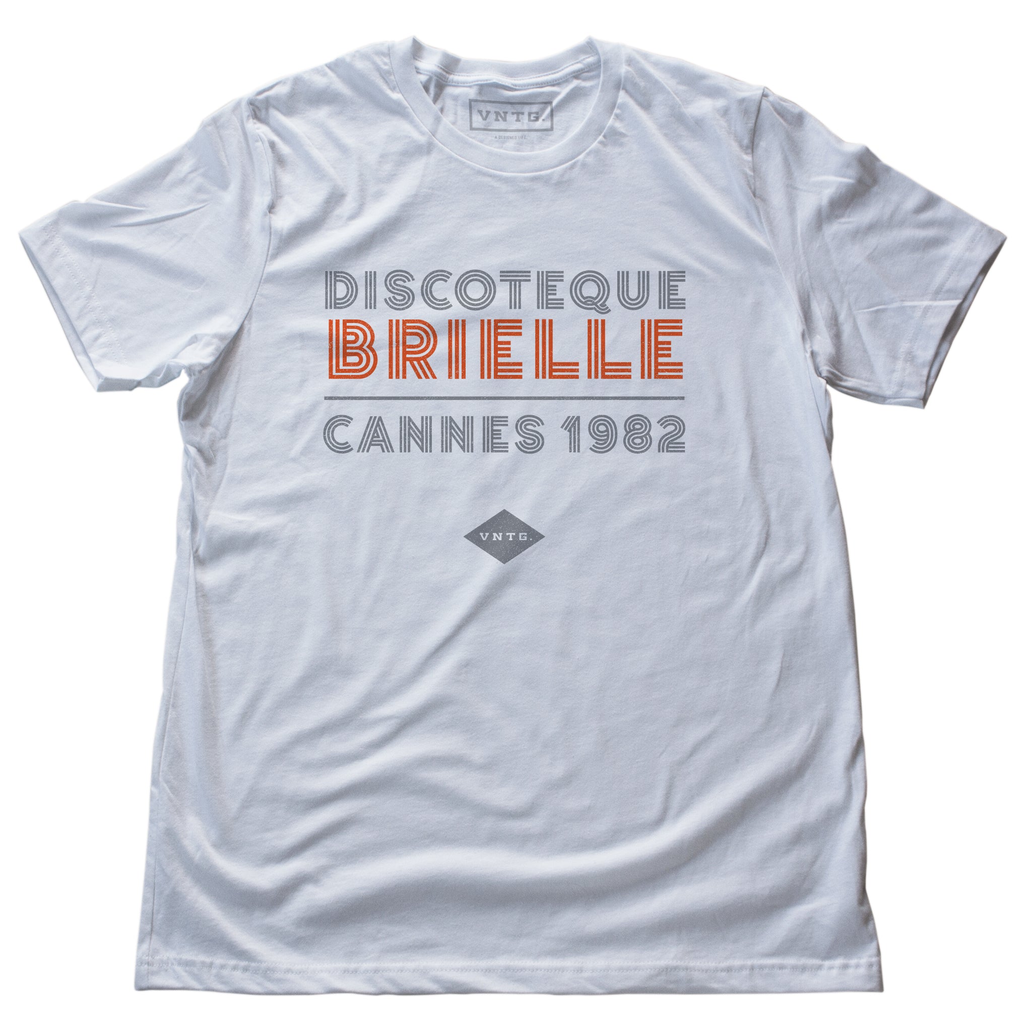 A fashionable classic white graphic tee, for a fictional Cannes, France disco from 1982. The retro typography reads “DISCOTEQUE BRIELLE / CANNES 1982” with the VNTG. diamond logo beneath. From Wolfsaint.net