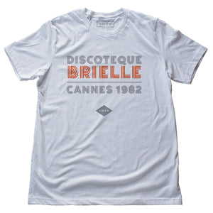 A fashionable classic white graphic tee, for a fictional Cannes, France disco from 1982. The retro typography reads “DISCOTEQUE BRIELLE / CANNES 1982” with the VNTG. diamond logo beneath. From Wolfsaint.net