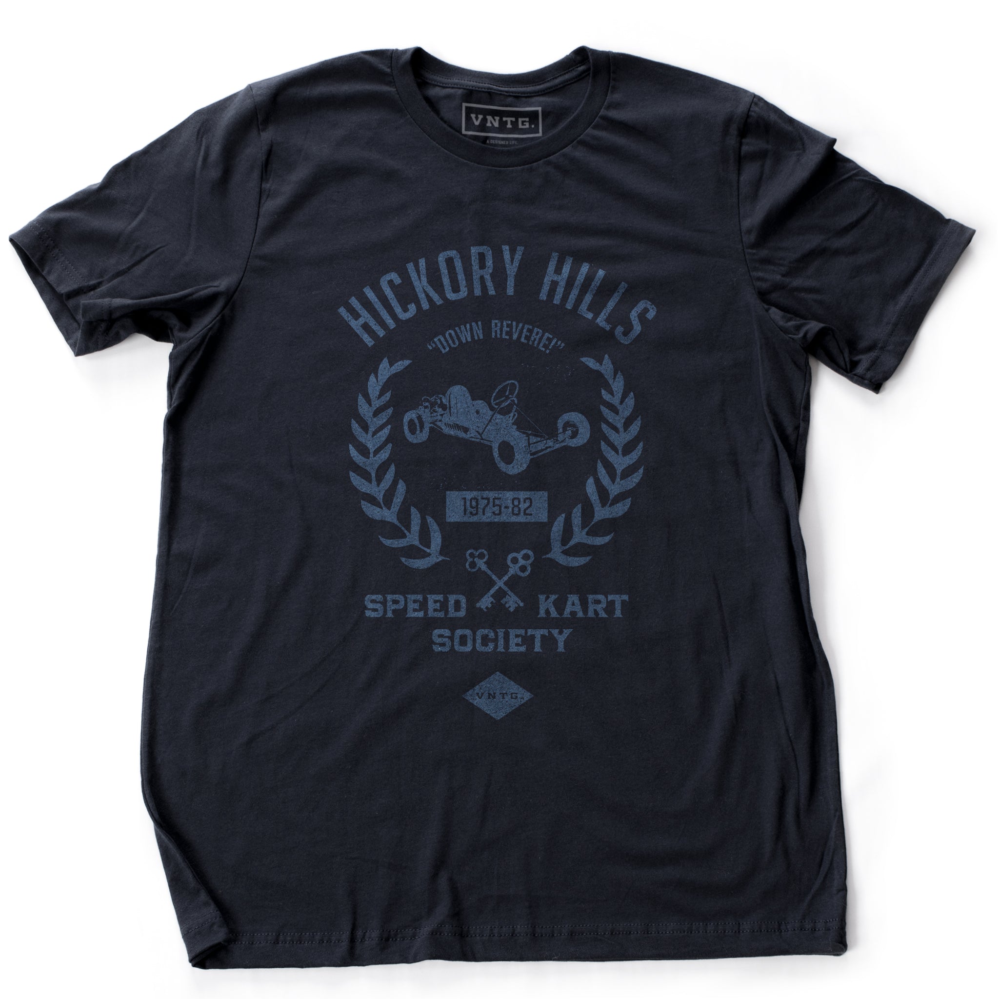 A ‘vintage fiction,’ retro t-shirt in Navy Blue, picturing a go-kart, promoting a small town racing league from 1975-1982 in Hockessin, Delaware. Inspired by the films of Wes Anderson. By fashion brand VNTG., from wolfsaint.net