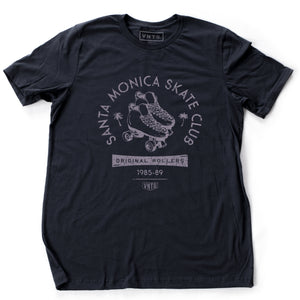 A vintage-inspired Navy Blue retro t-shirt for the fictitious Santa Monica Skate Club, “original rollers 1985-89” featuring a pair of quad roller skates and palm trees. By fashion brand VNTG. for Wolfsaint.net