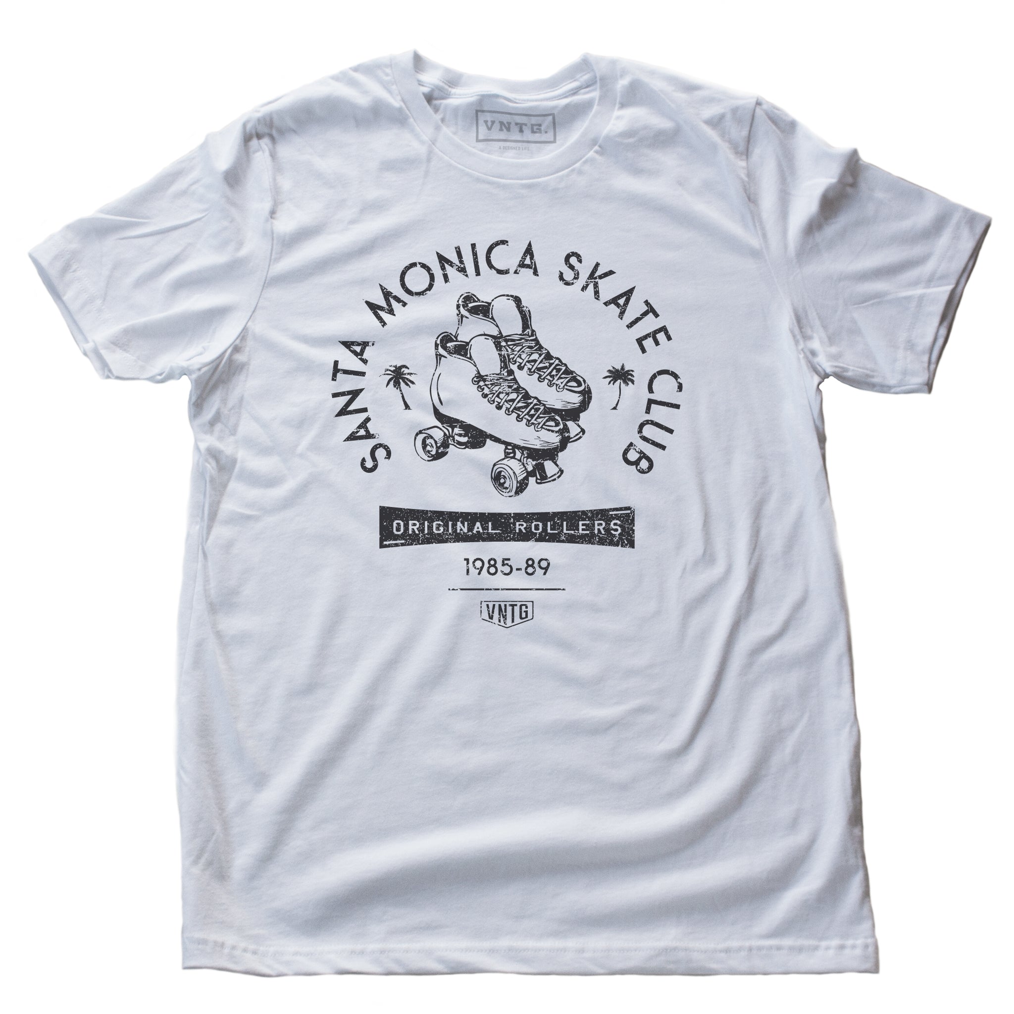 A vintage-inspired retro t-shirt in White for the fictitious Santa Monica Skate Club, “original rollers 1985-89” featuring a pair of quad roller skates and palm trees. By fashion brand VNTG. for Wolfsaint.net