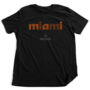 A stylish fashion-shirt in Classic Black, with a colorful graphic modern typographic treatment of “miami” in orange crosshatched lowercase letters, with the Wolfsaint logo beneath it. From wolfsaint.net