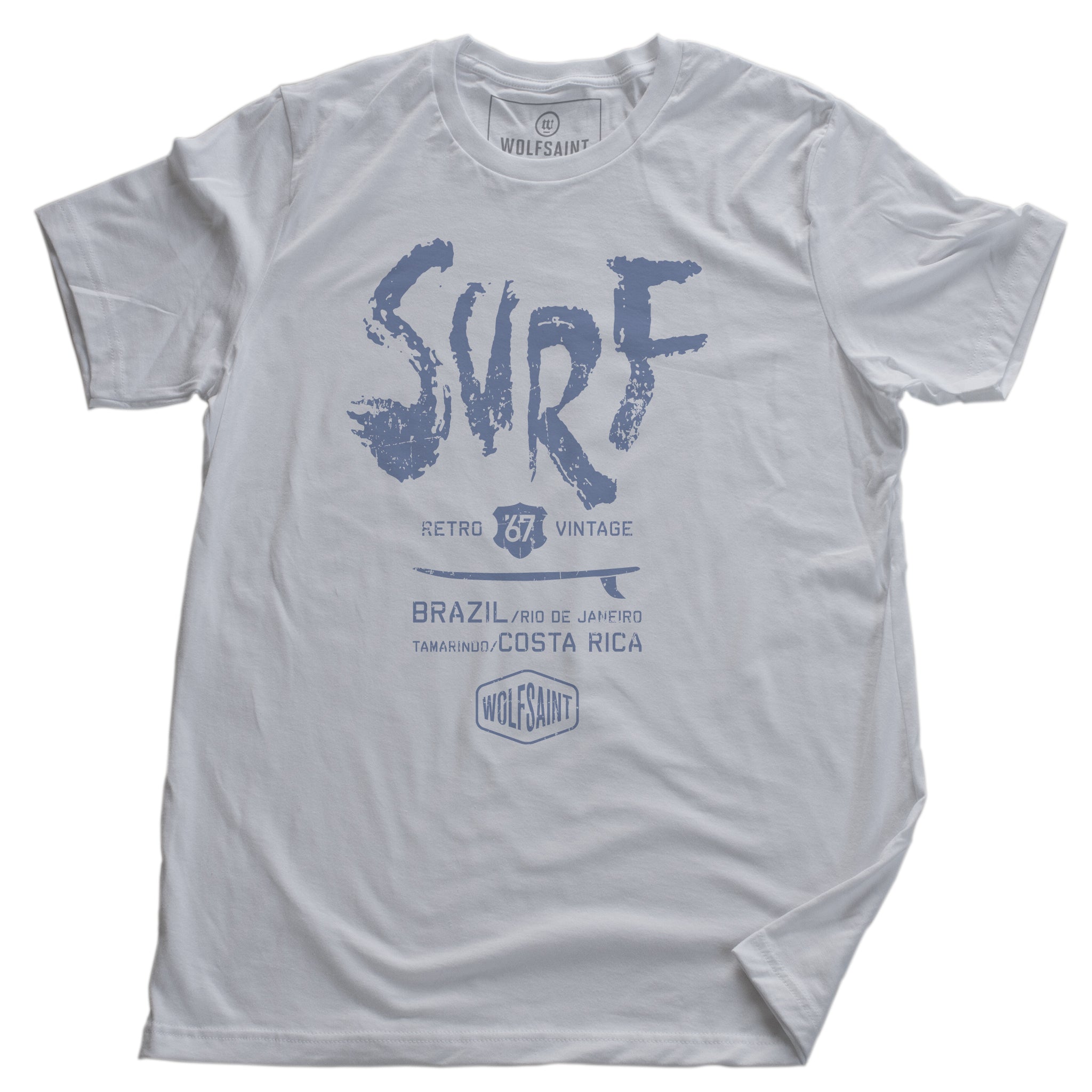A fashionable graphic t-shirt with a retro, vintage design. This shirt features a surfboard graphic beneath large painted type which reads “SURF” and below it “Brazil, Rio de Janeiro, and Tamarindo, Costa Rica” above the Wolfsaint logo.  For wolfsaint.net
