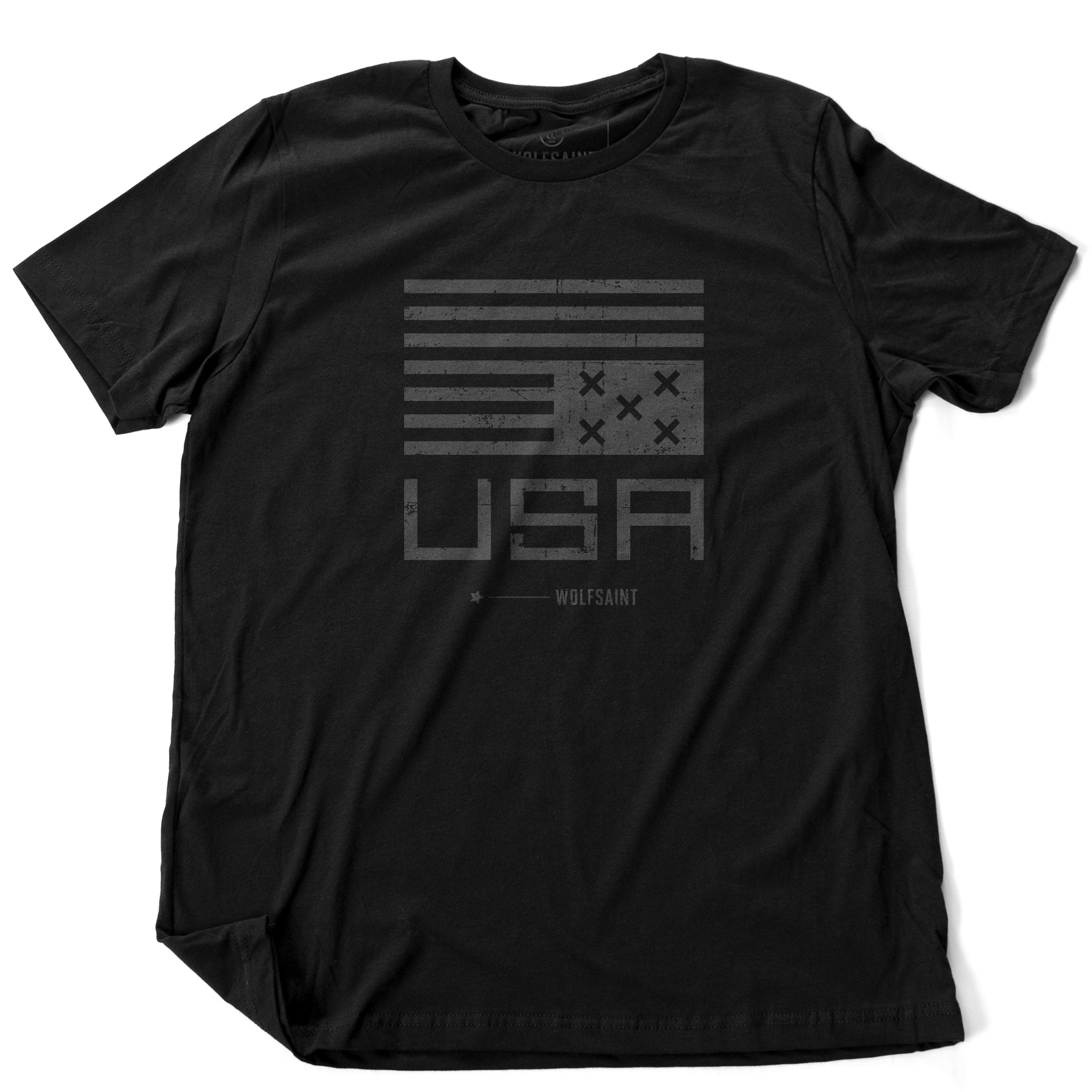 A classic graphic t-shirt featuring a political statement about the American democracy, showing an upside down simplified American flag with Xs instead of stars, above the letters “USA” and the WOLFSAINT gothic logo. From wolfsaint.net