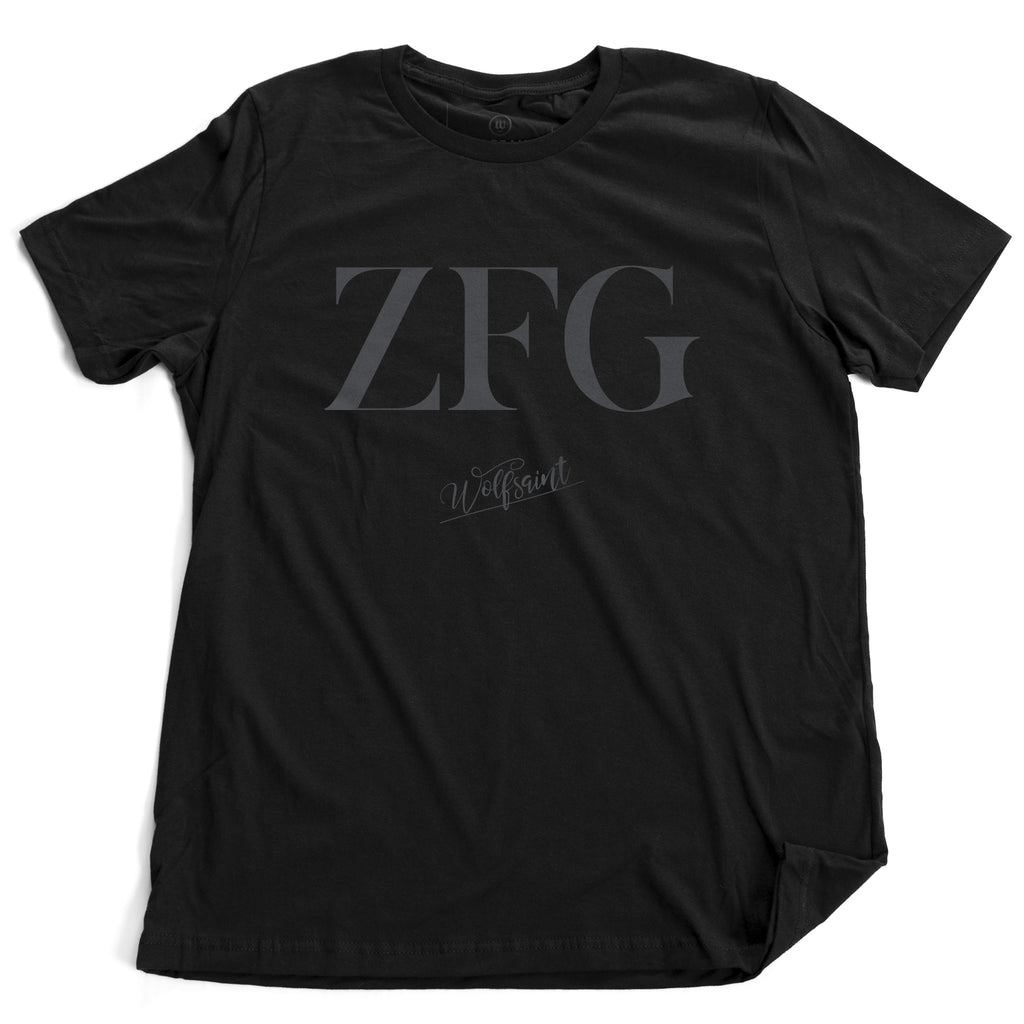 An elegant fashionable black graphic t-shirt that ironically represents a sarcastic and vulgar contemporary meme phrase “zero fucks given,” a version of “no fucks given”—in this case, the typography says only “ZFG” in a large fashion magazine font. By WOLFSAINT, available from. Wolfsaint.net