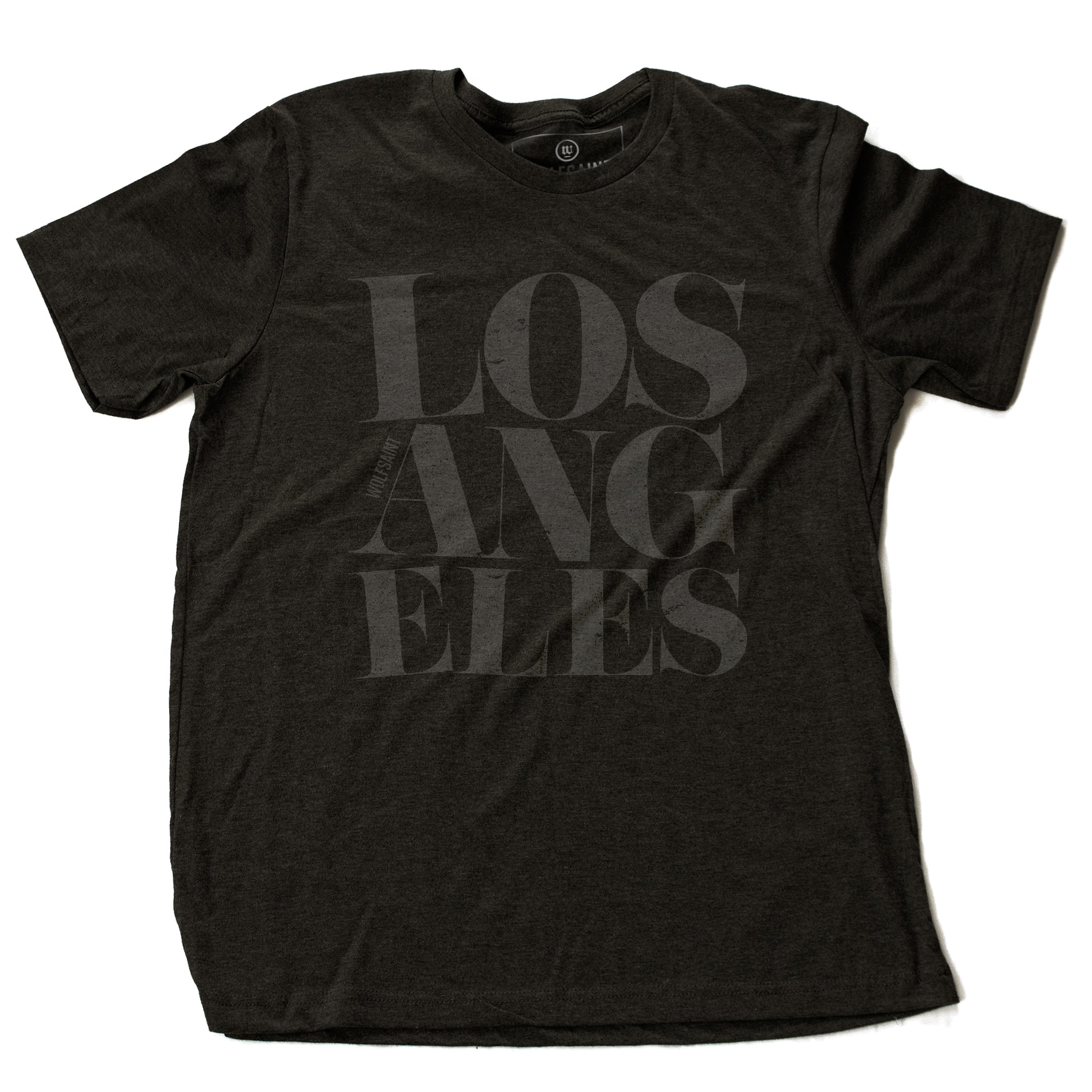 A fashionable Dark Gray Heather graphic t-shirt featuring the word “LOS ANGELES” in a elegant font, stacked in three tilted lines to sarcastically simulate an earthquake. From wolfsaint.net