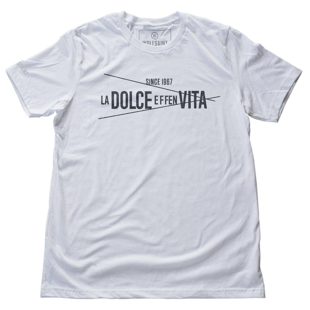 A WHITE fashion t-shirt with a clean graphic with a sarcastic version of a classic Italian phrase: “LA DOLCE EFFEN VITA” — the sweet f***ing life, by fashion brand Wolfsaint.net 