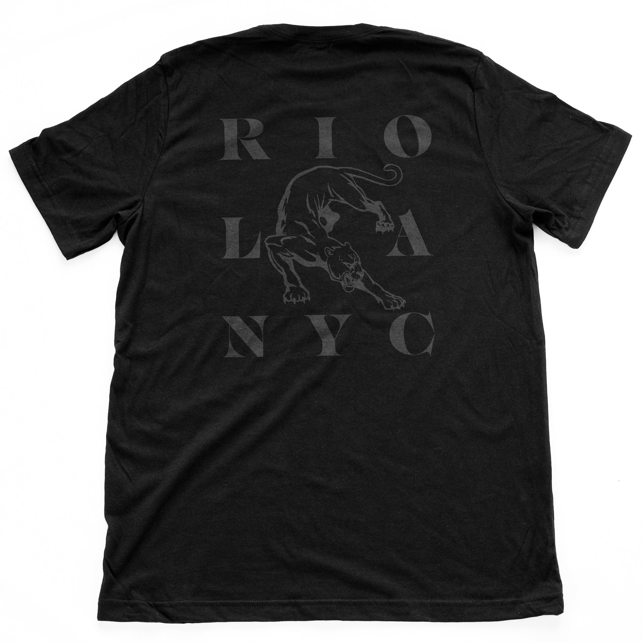 The back of a graphic t-shirt for the Wolfsaint brand, with a big panther surrounded by Wolfsaint cities NYC, LA, and Rio on the back. In Classic Black. From Wolfsaint.net 