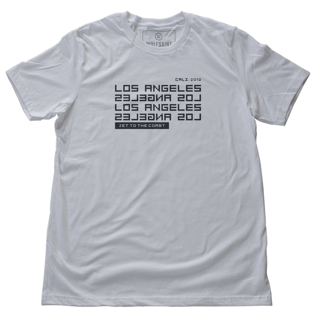A stylish t-shirt in white, with modern/futuristic type graphic reading “LOS ANGELES” in forward and reverse, and the words “jet to the coast” below. From wolfsaint.net