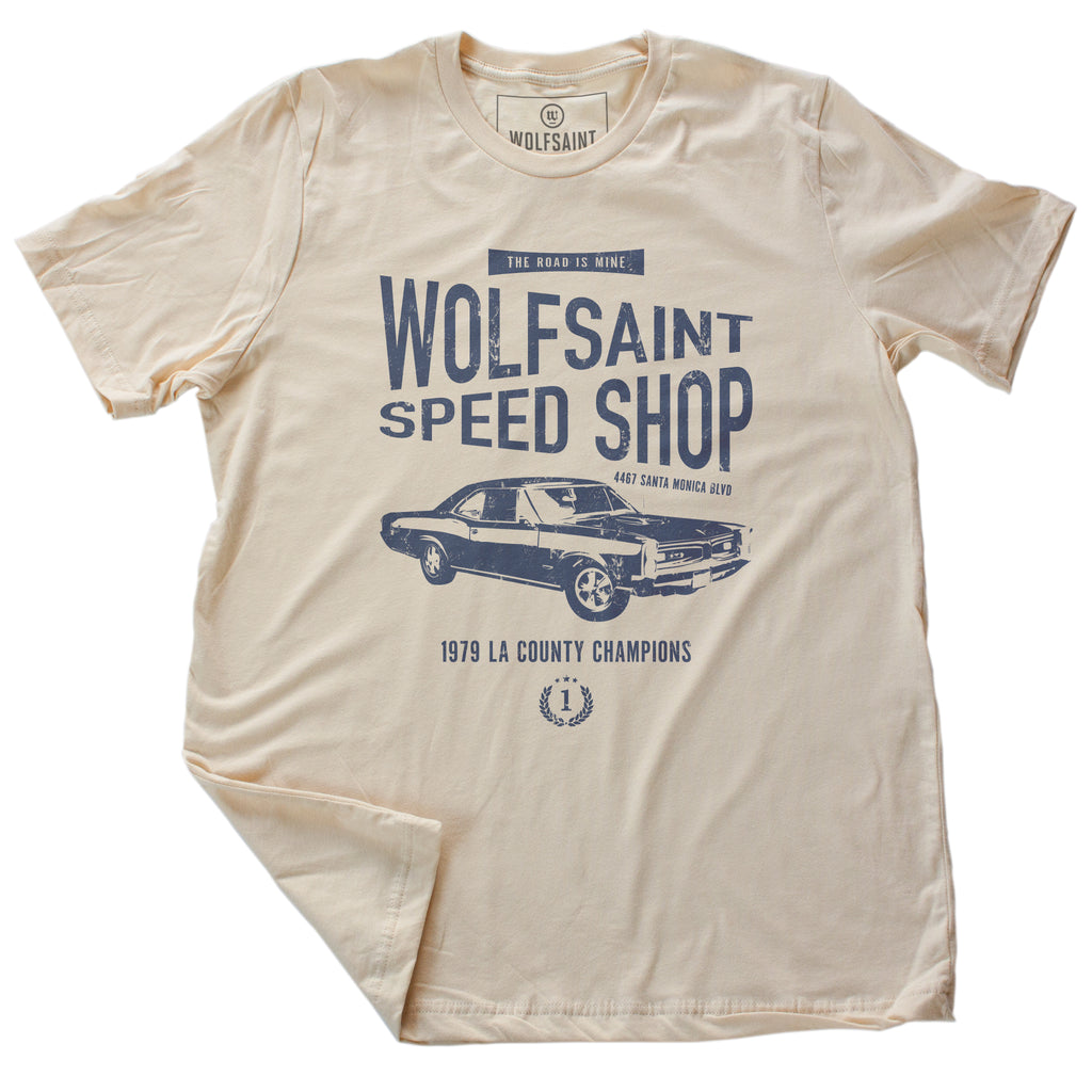 A vintage styled retro graphic t-shirt for the fictitious Wolfsaint Speed Shop, featuring a graphic of a classic Pontiac GTO and the words “the road is mine.” From Wolfsaint.net