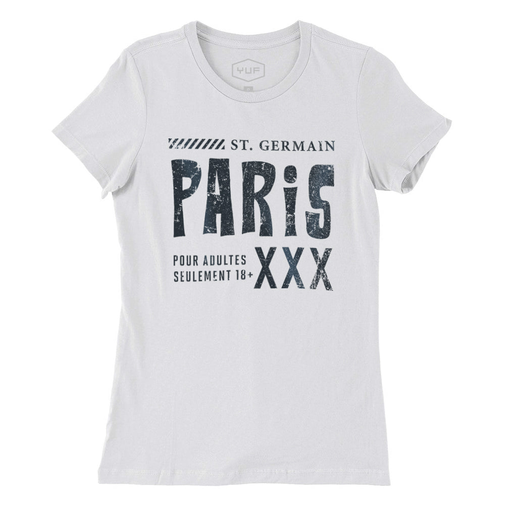 A fashionable, vintage-inspired retro graphic women’s t-shirt in Classic White. On the shirt is a sarcastic promotion of the adult entertainment district in St. Germain, with the large word “PARIS” and “XXX” most prominent. By fashion brand YUF. From wolfsaint.net