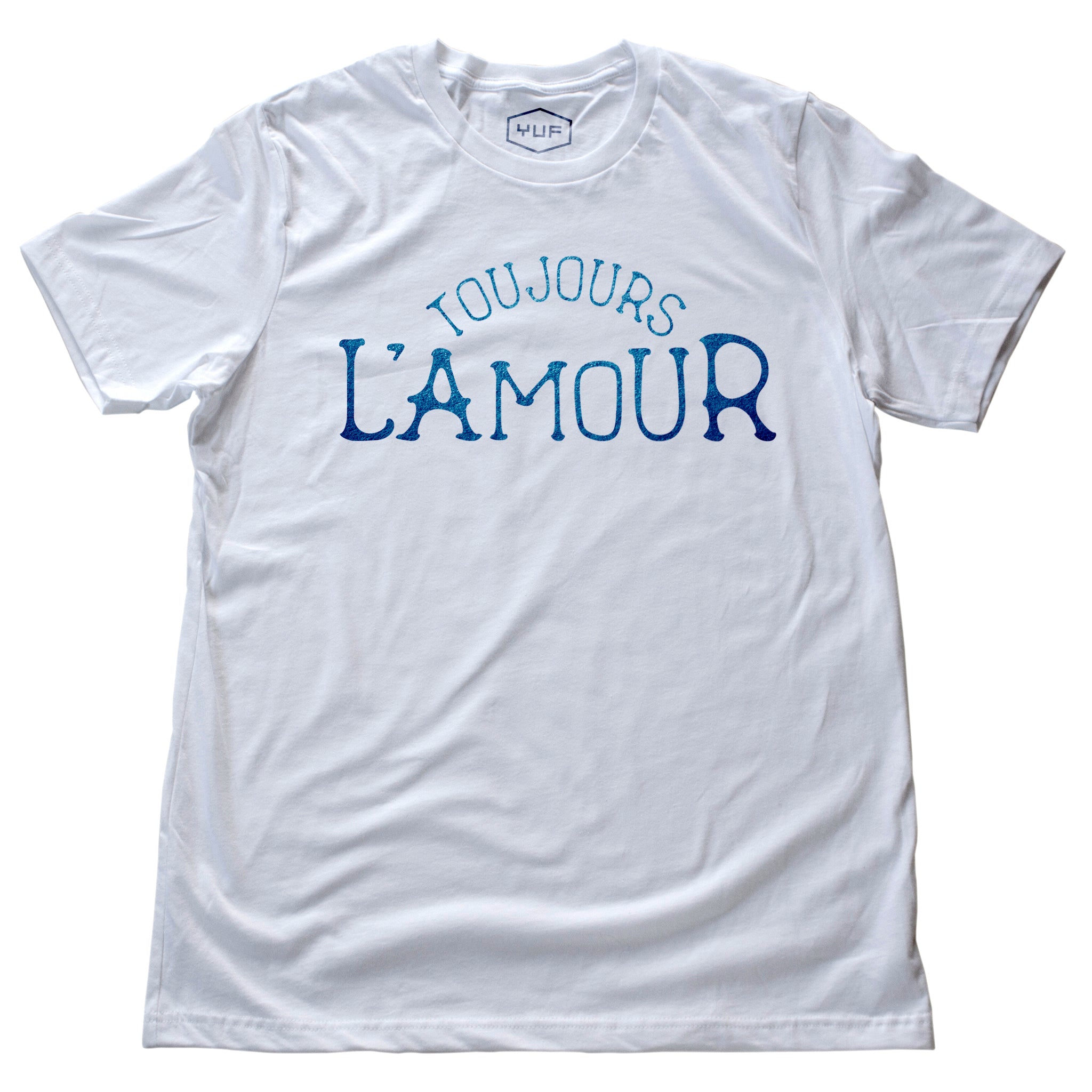 A unisex fashion t-shirt in Classic White with the retro, vintage-inspired typographic statement “TOUJOURS L’AMOUR,” French for “love always.” By fashion brand YUF, from Wolfsaint.net