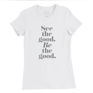 A women’s cut fashion t-shirt in Classic White, with elegant typography in a vertical stack: “See the good. BE the good.” By fashion brand YUF, for wolfsaint.net